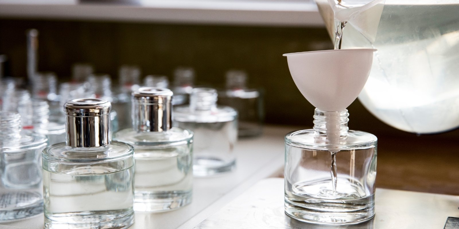 An image of different perfume bottles filling with synthetic ingredients