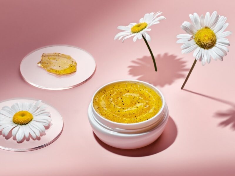 An image of gel product with flowers around it