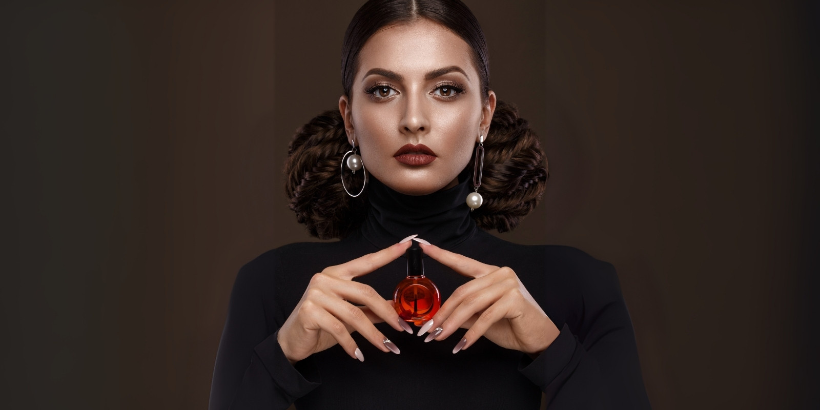 An image of a woman with a perfume in her hand