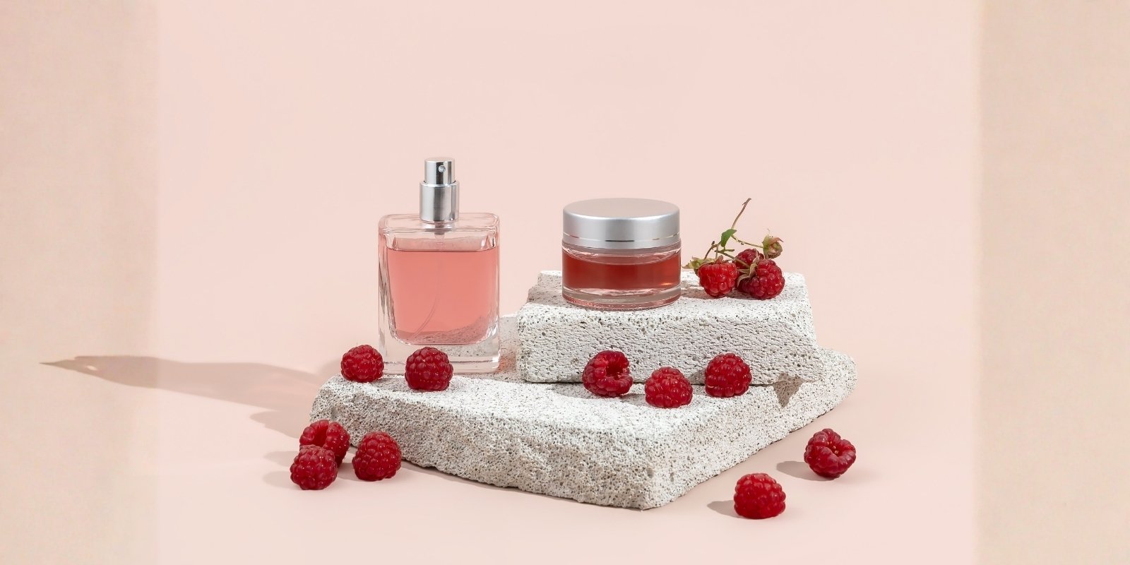An image of berries and a perfume